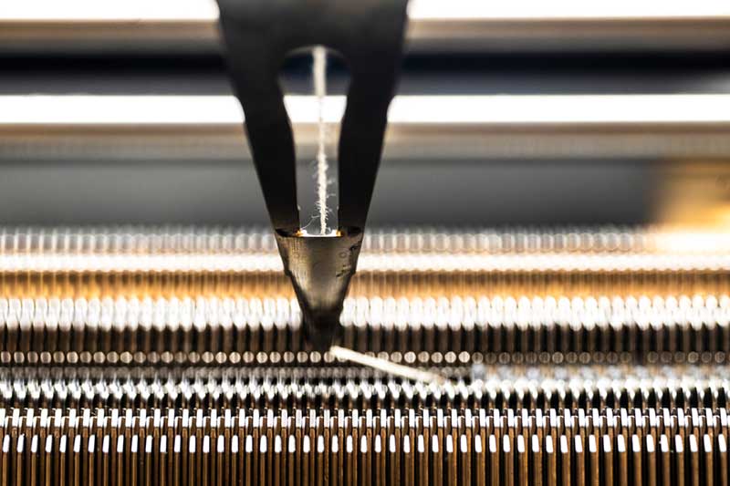 Megan Hofmann’s knitting machine creates a shawl for Elizabeth Mynatt. Mynatt wore the shawl for her American Academy of Arts and Sciences induction. Photo by Alyssa Stone/Northeastern University