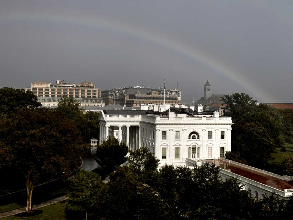 The view of the White House from the OSTP office on Pennsylvania Avenue. A rainbow appears in the background behind the White House.