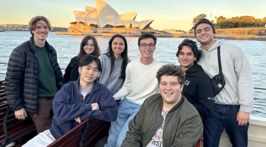 8 Khoury students pose for a photo with the Sydney Opera House in the background