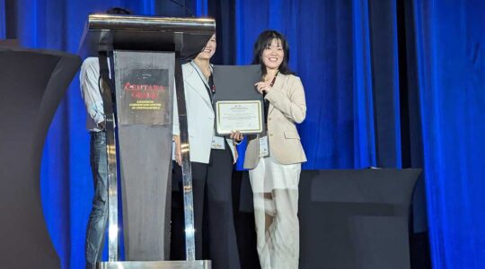 Weiyan Shi holds her certificate at the Annual Meeting of the Association for Computational Linguistics