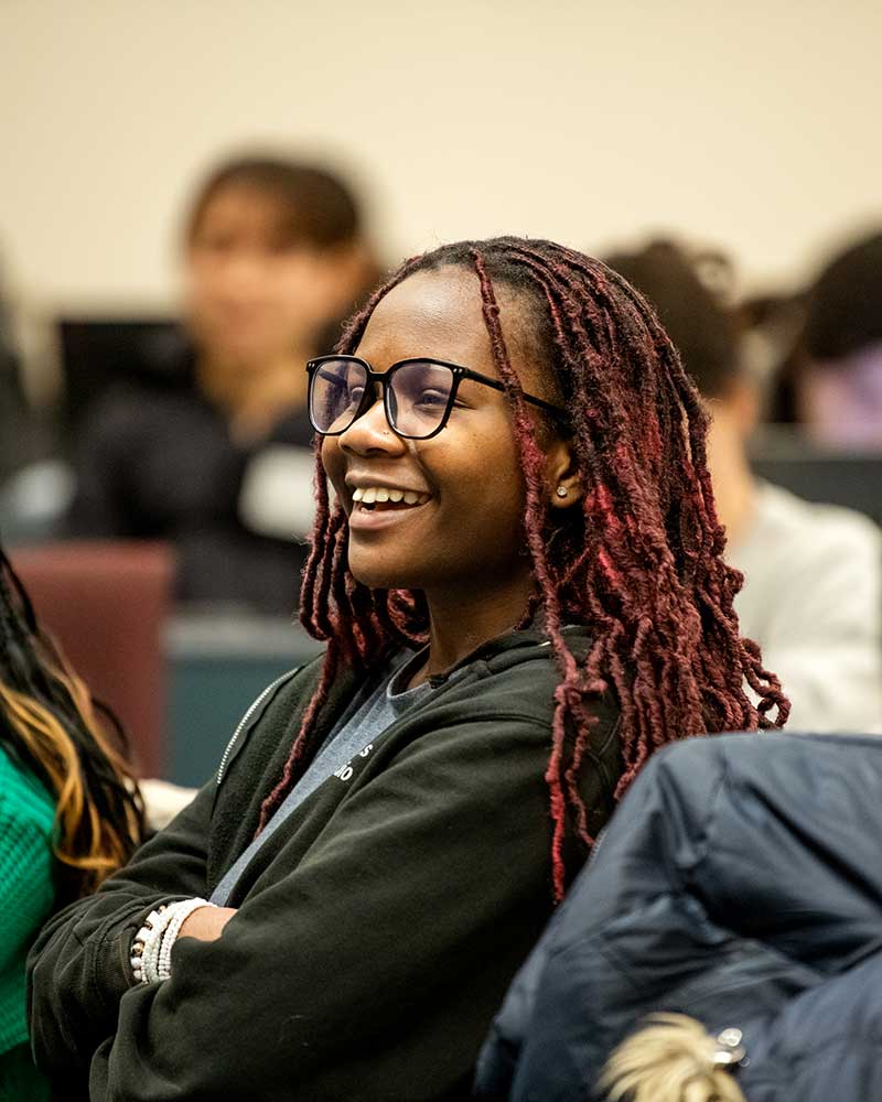 A Khoury student smiles during a class presentation