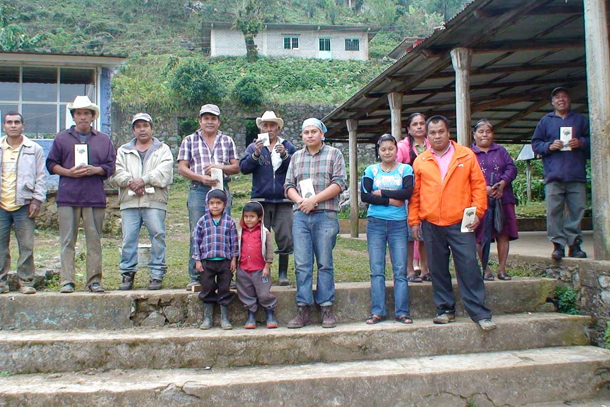 Several rural community members pose for a photo