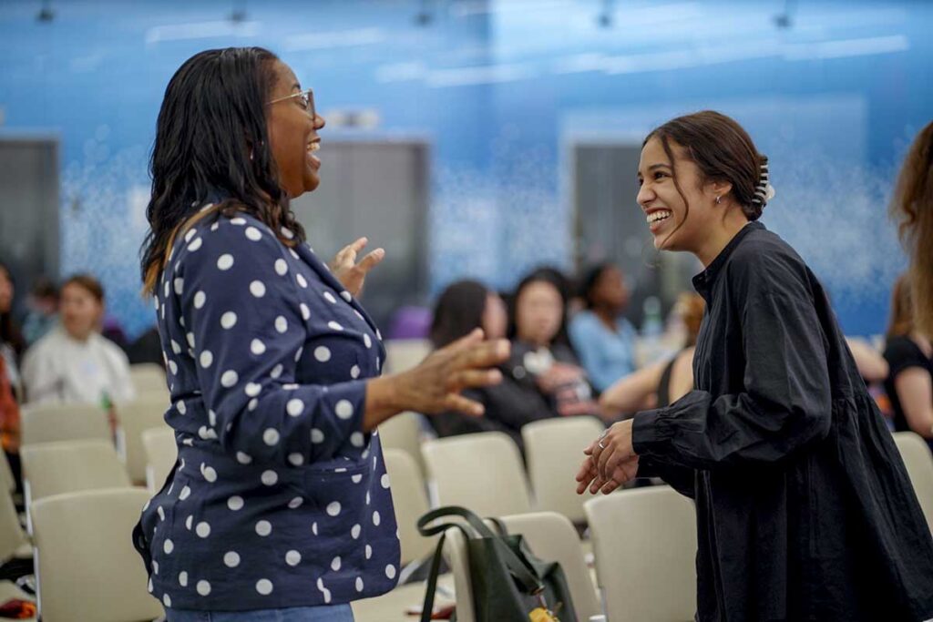 Two students laugh during an event in a Khoury lab