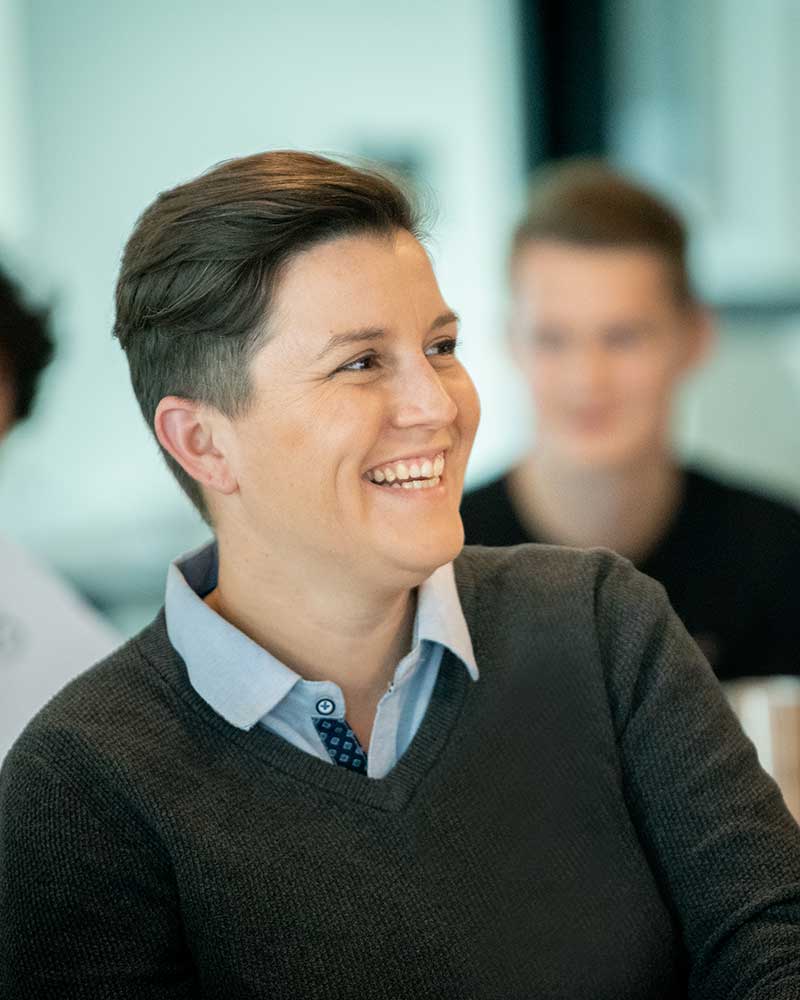 A student smiles while viewing a class presentation