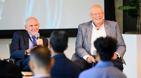 Usama Fayyad, executive director of Northeastern’s Institute for Experiential AI, speaks with Larry Brilliant, CEO of Evity.AI . Photo by Matthew Modoono/Northeastern University