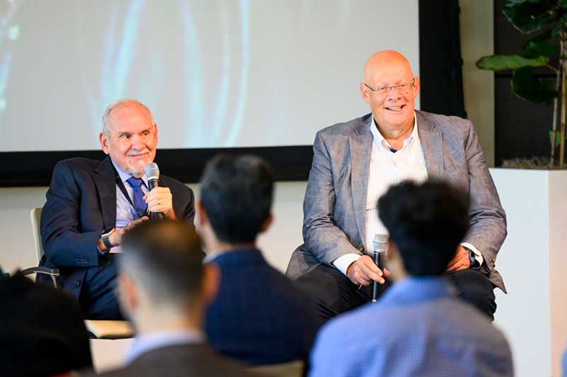 Usama Fayyad, executive director of Northeastern’s Institute for Experiential AI, speaks with Larry Brilliant, CEO of Evity.AI . Photo by Matthew Modoono/Northeastern University