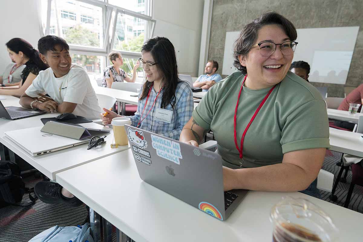 Students sit in a classroom and have a cheerful conversation