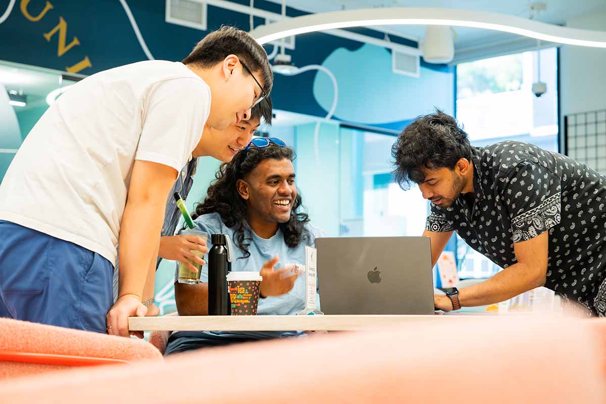 Students laugh as they work on a project