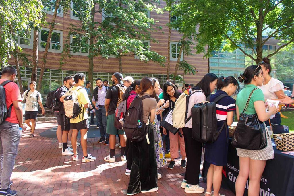 Students gather at an outdoor tabling event during welcome week