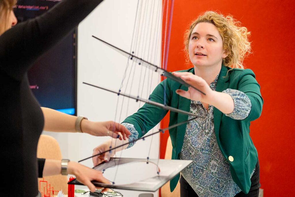 A researcher holds on to pieces of plastic attached to several strings