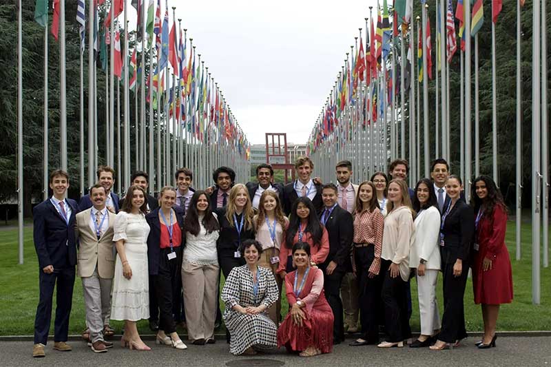 Shannen Espinosa poses with several college students and employees outside the UN office in Geneva, Switzerland