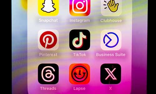 A photo showing a phone's homescreen with several app icons, including TikTok