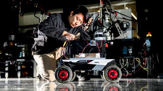 Zihao Dong, a Northeastern doctorate student, tested the algorithm on Northeastern’s Agile X Scout Mini mobile robot. Photo by Matthew Modoono/Northeastern University