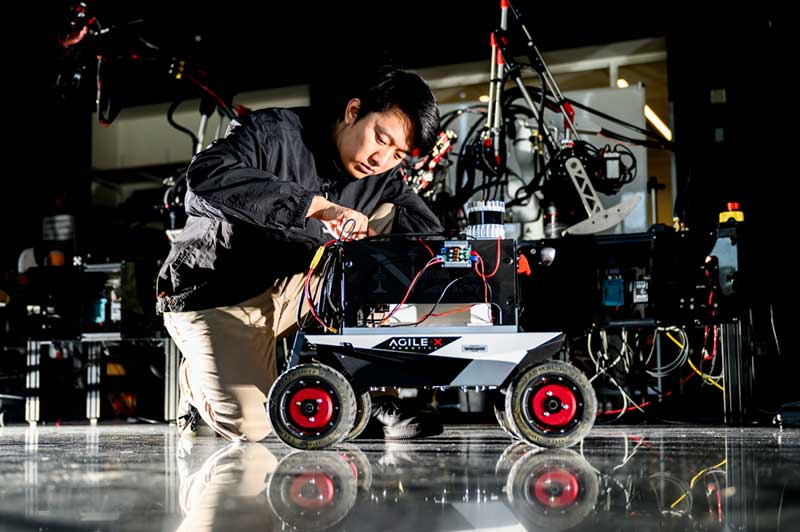 Zihao Dong, a Northeastern doctorate student, tested the algorithm on Northeastern’s Agile X Scout Mini mobile robot. Photo by Matthew Modoono/Northeastern University