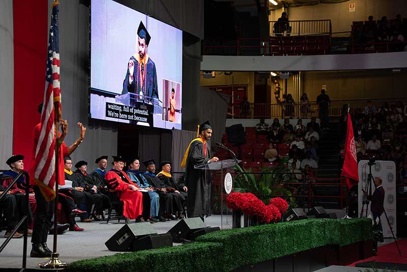 Graduate ceremony speaker Neel Sortur stands at the podium and addresses the crowd