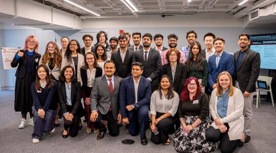 Khoury research showcase students pose for. a photo with Khoury staff