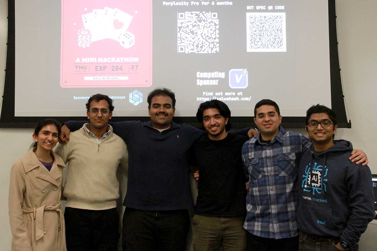 Six members of the ACM club stand in front of a presentation screen about a mini hackathon event