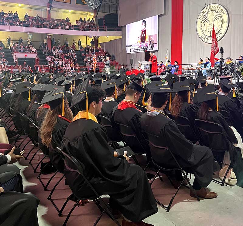 Rows of graduates listen to one of the ceremony speeches