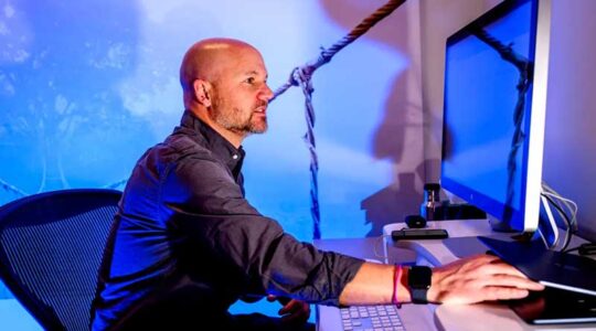 Matthew Goodwin works in front of a computer