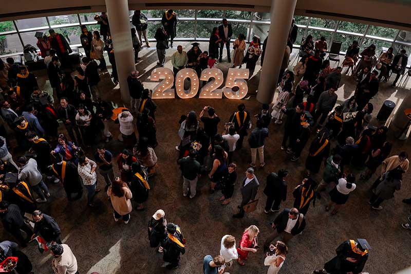 Khoury College's Seattle students gathered in a building's atrium to mark their commencement.