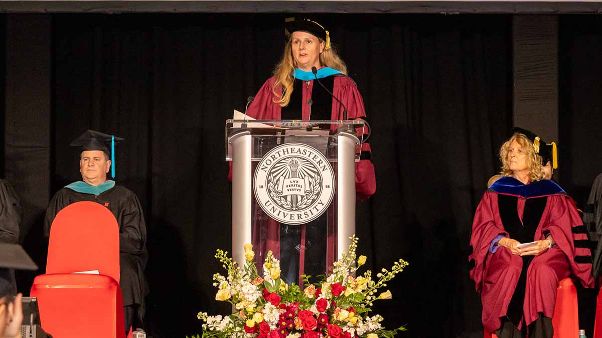 Regional Dean and CEO Jamie Jones Miller addresses attendees in the George Washington Memorial Theater