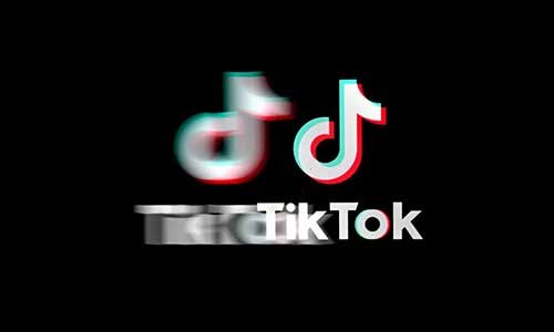 The TikTok logo appears on a black screen. There is a blurry rendering of the logo in the background.