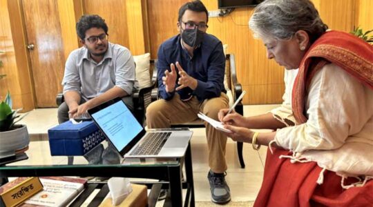 Upol Ehsan (center) explains responsible AI fundamentals to the Hon. Sharmeen Murshid (right), the leader of Bangladesh’s Ministry of Social Welfare.
