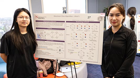 Two Khoury students pose beside their project poster titled, "Maximum Flow Algorithm - Dinic's"