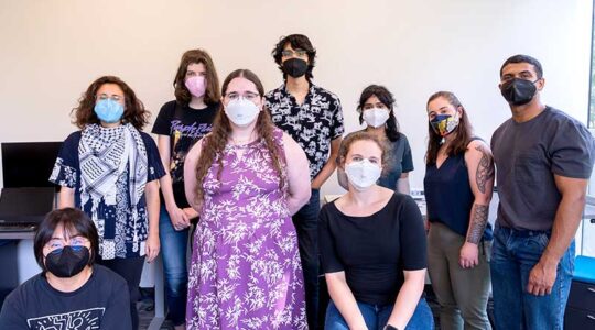 Michael Ann DeVito (fourth from left) stands between eight other researchers in SEALab's lab space