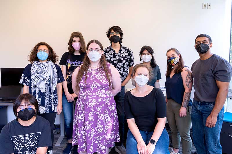 Michael Ann DeVito (fourth from left) stands between eight other researchers in SEALab's lab space
