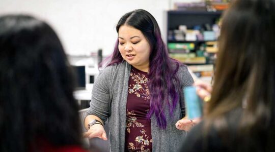 Alexandra To talks to a group of students in a lab