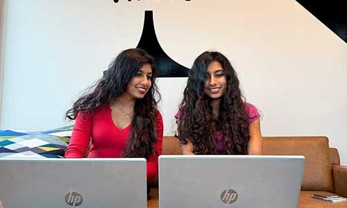 Reena and Reemaa Sajad Hyder type at their laptop computers
