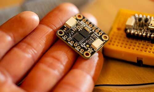 a hand holds a microchip used in an adaptive splint