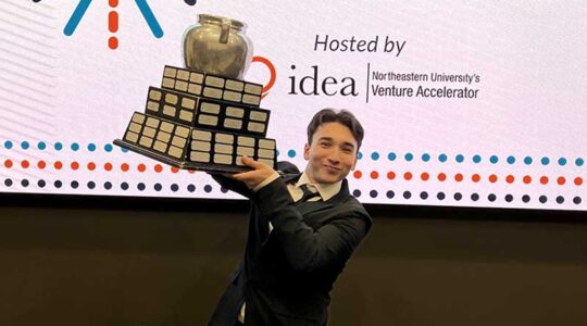 Mouad Tiahi raises a trophy after The Beanpot of Ventures event