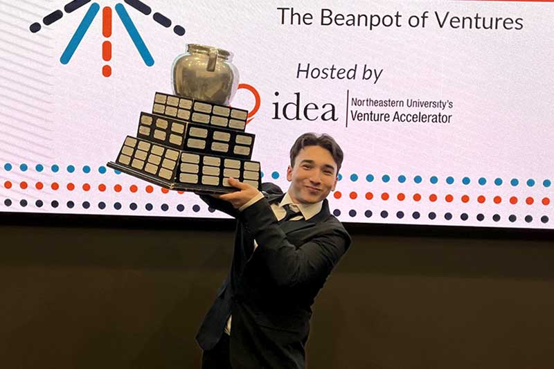 Mouad Tiahi raises a trophy after The Beanpot of Ventures event