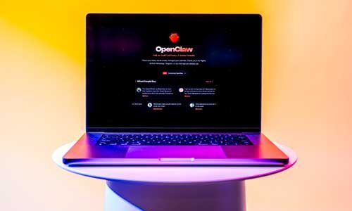 A laptop screen shows the homepage of openclaw.ai