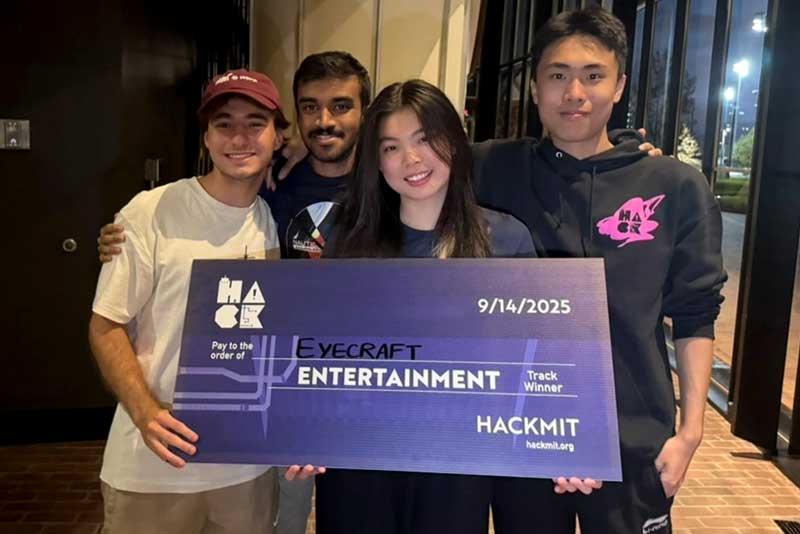 Left to right: Tomas D’Avola, Troy Gunawardene, Xiaole Su, and Qihong Wu pose with a novelty check