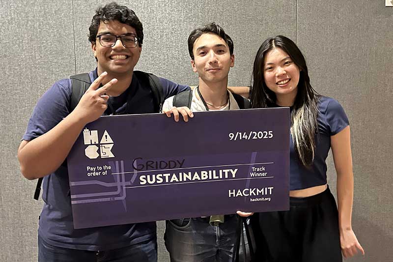 Shresht Bhowmick (left) and Mouad Tiahi (center), members of the Griddy team, hold their novelty prize check alongside Xiaole Su