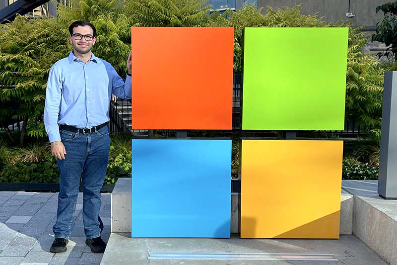 Benjamin Meyer stands next to a model of the Microsoft logo