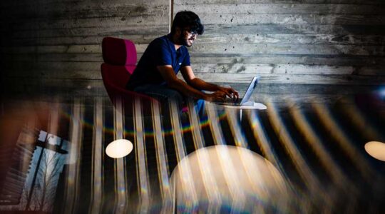Shubh Thorat, a fourth-year student at Northeastern, works on his laptop during his co-op at Amazon Web Services