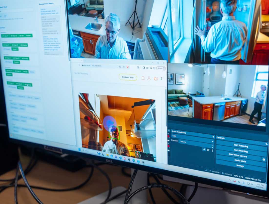 A computer screen showing different views of Khoury faculty Timothy Bickmore moving around a kitchen inside a laboratory