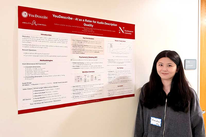 Zhenzhen Qin stands next to the research poster for the YouDescribe project