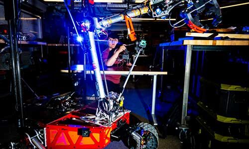 Salem Chen, a rising second year mechanical engineering major, works on the arm remote of the Mars rover.