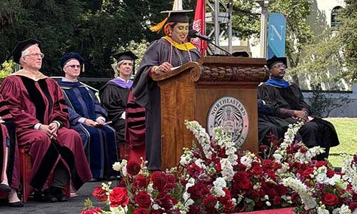 Khoury graduate Aisha Abdur Rahim speaks from behind the podium at the Silicon Valley graduation celebration