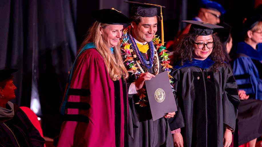 Khoury graduate Philip Fochios (center) shares a moment with Northeastern Arlington CEO and Regional Director Jamie Jones Miller (left) and Director of Computing Programs (Arlington) and Teaching Professor Huihui Wang