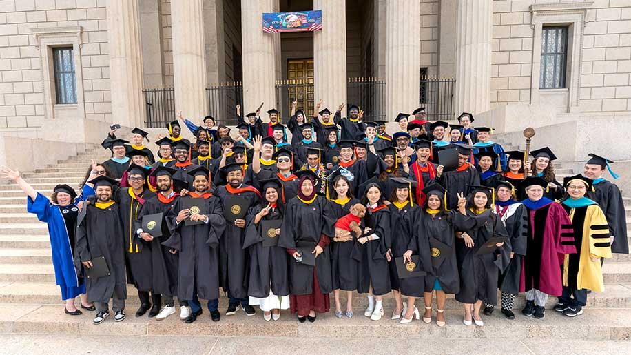 Northeastern Arlington's 63 graduates, including 22 from Khoury College, pose for a photo on the steps of the George Washington Masonic National Memorial Hall
