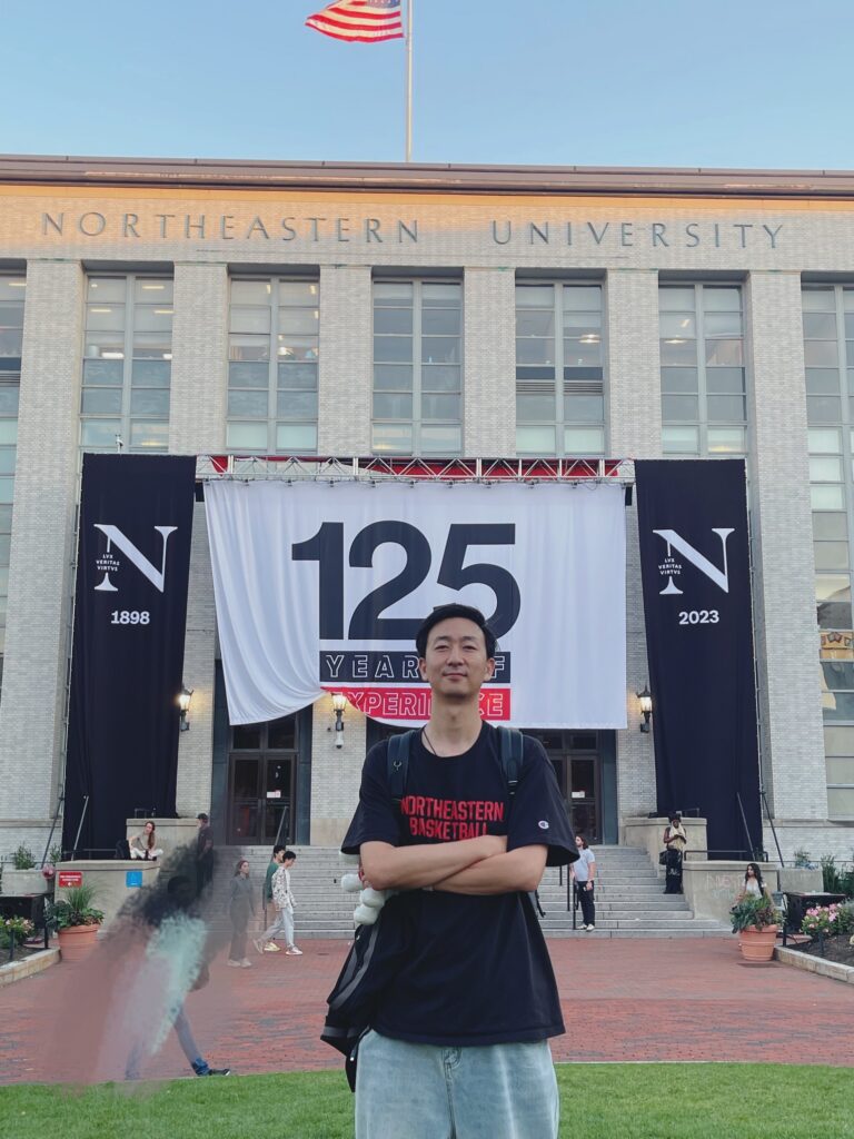 Northeastern master's graduate Denfeng “Jackie” Jiang in front of the Krentzman Quad at Northeastern