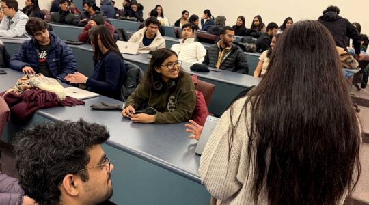 Several rows of NU Launch Labs members discuss projects during a club meeting