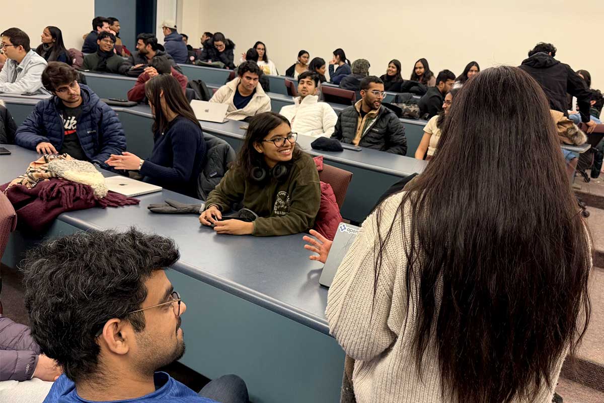 Several rows of NU Launch Labs members discuss projects during a club meeting
