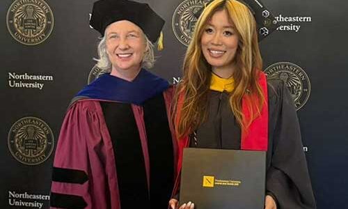 Songting Yang (right) holds up her diploma while standing next to Silicon Valley Dean Caroline Simard